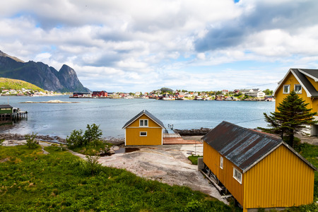 Scenic town of Reine by the fjord on Lofoten islands in Norway on sunny summer dayの写真素材