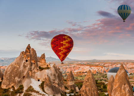 Hot air balloon flying over Cappadocia region, Turkeyの写真素材