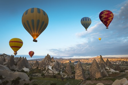 Hot air balloon flying over Cappadocia region, Turkeyの写真素材