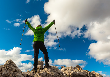 Hiker enjoying view from top of mountain, Dolomites, Italyの写真素材