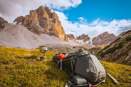 Camping gas, backpack and tourist equipment on Alps backgroundの写真素材
