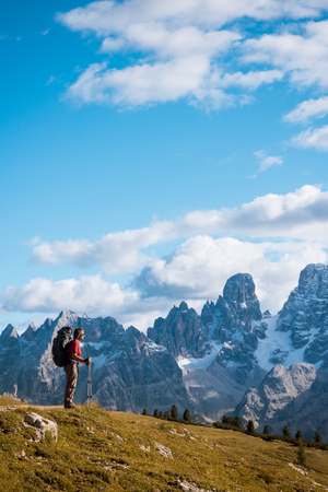hiker in front of Alps mountains, Dolomites, Italyの写真素材