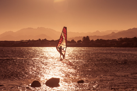 Windsurfer sailing in sunset sea, Red sea, Dahabの写真素材