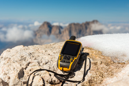 GPS navigator in hand against Dolomites Alps