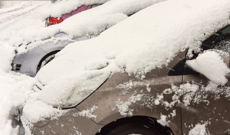 Winter cars covered with fresh white snowの写真素材