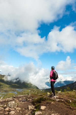Happy sporty woman enjoy beautiful lake and good weather in Norwayの写真素材