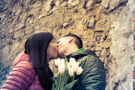 Date of middle aged Loving couple kissing at spring city streetの写真素材