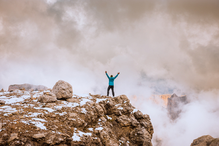 Woman on top rock , Success victory concept. Sella Ronda Dolomites Italyの写真素材