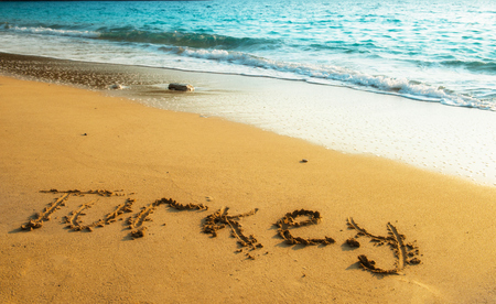 Turkey written on sandy beach of summer sunset over Mediterranian seaの写真素材