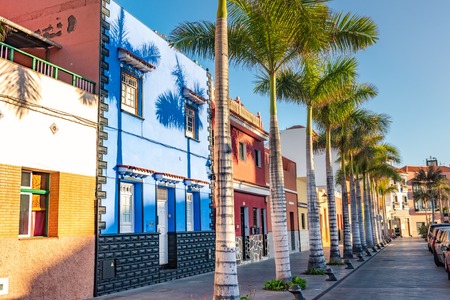 Tenerife. Colourful houses and palm trees on street in Puerto de la Cruz town, Tenerife, Canary Islands, Spain.の写真素材