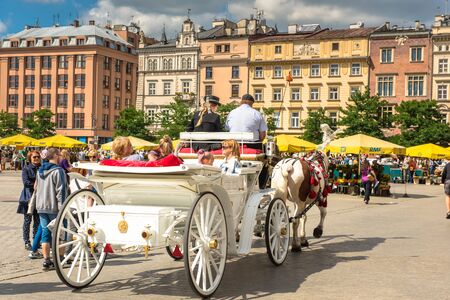 KRAKOW, POLAND - July 05, 2018: a horse and carriage carries tourists in Krakow, Poland
