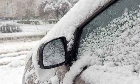 Winter cars covered with fresh white snowの写真素材