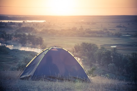 Tourist tent at riverbank Sommer sunrise. Active lifestyle and healthy conceptの写真素材