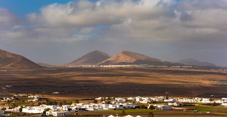 Typical Canarian village or town with white houses and volcanic landscape, Nazaret, Lanzarote island, Canary, Spainの写真素材