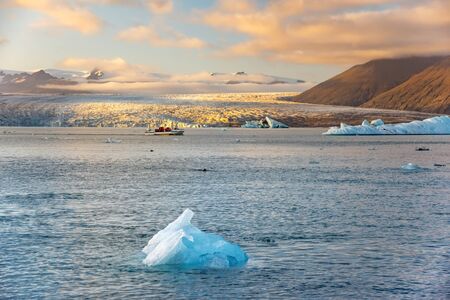 Ice Lagoon. Icebergs floating in Jokulsarlon glacier lagoon lake at sunset. South Iceland,...