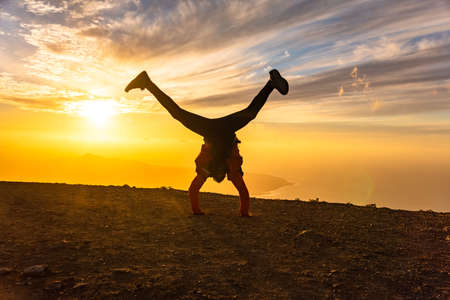 Happy man jumping for joy at sunset. Success, winner, happiness, ttavel concept.の写真素材