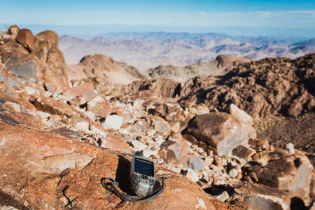 GPS navigator against empty stone desert landscapeの写真素材