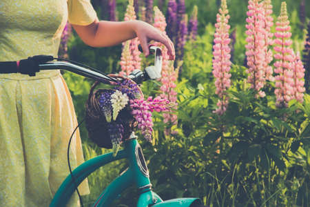 Teen girl in hat on flowered sunset meadow. Peace, happyness , freedom and youth conceptの写真素材