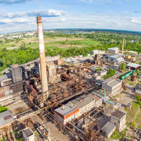 Aerial drone shot of old industrial zone with smoke stack. Air pollution conceptの写真素材