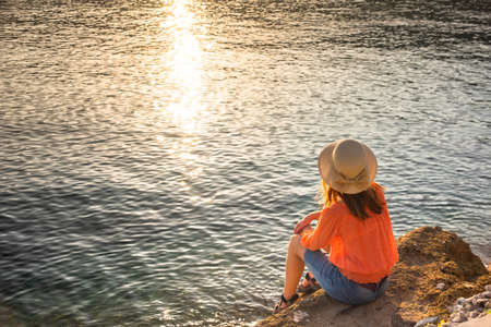 back view of young girl over sea sunset on Amalfi coast. Travel, relax, vacationの写真素材