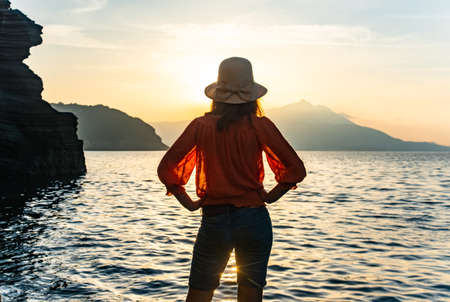 back view of young girl over sea sunset on Amalfi coast. Travel, relax, vacationの写真素材