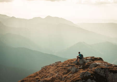 man on the top of a rockの写真素材