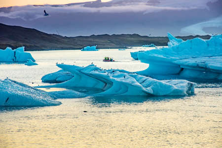 Icebergs floating in Jokulsarlon glacier lagoon lake at sunset
