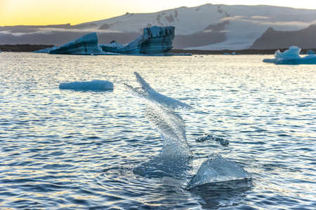 Icebergs floating in Jokulsarlon glacier lagoon lake at sunset