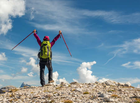 Active hiker hiking, enjoying the view, looking at Dolomites mountains landscapeの写真素材