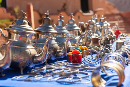 Moroccan craft souvenirs on street market. Teapots, jewelry, tagines, trinketsの写真素材