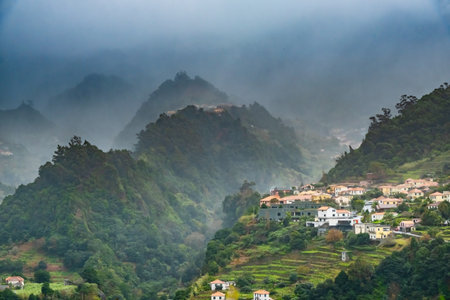 Traditional terrace village Sao Vicente, Madeira Island, Portugal. Small houses and gardens among a...