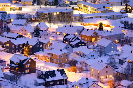 Norwegian city of Tromso. Little glowing snowy fairy houses at christmas