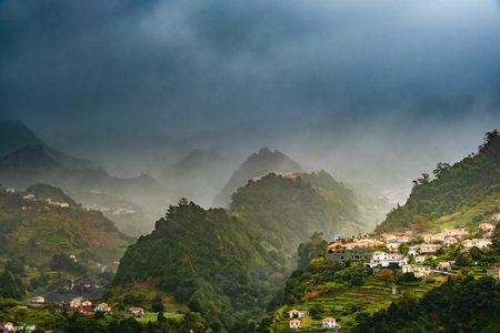 Traditional terrace village Sao Vicente, Madeira Island, Portugal. Small houses and gardens among a...