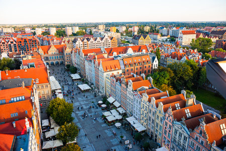 Aerial view of Gdansk at sunset, showcasing the downtown area and St. Marys Basilica. The historical...