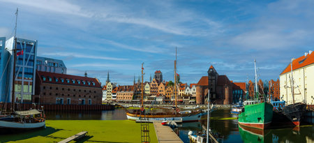 Scenic view of a marina on a sunny day, featuring a variety of yachts docked along the pier in...