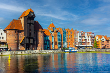 Scenic view of the historic waterfront in Gdansk, showcasing colorful buildings and the medieval...