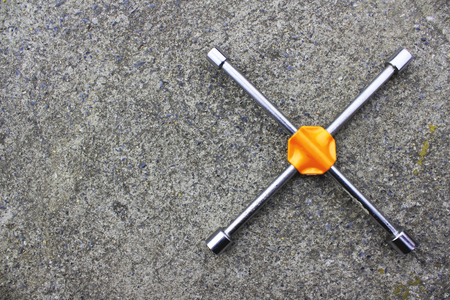 4-way wrench to remove the wheel on roadの写真素材