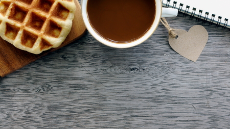 Coffee and waffles on wooden background, Notebook, Space for text.の写真素材