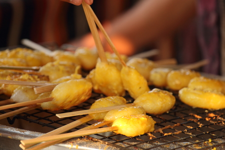 Kao ji is the grilled sticky rice. Before it was grilled, it was dipped into the egg .の写真素材