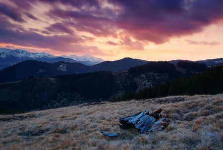 Evening in mountains and the cloudy sky painted by the sunの写真素材
