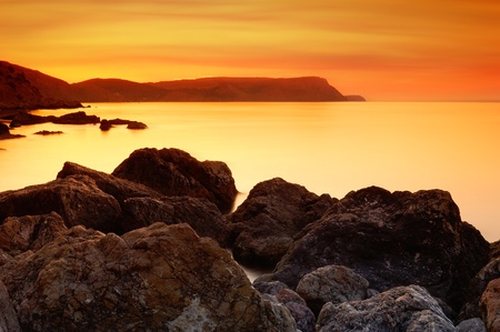 Sea landscape with a sunset and the cloudy sky の写真素材