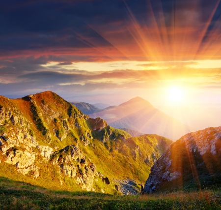 The first beams of a rising sun shine mountains Carpathians, Ukraine