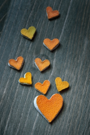 Hearts from the peel of citrus fruit on a wooden boardの写真素材