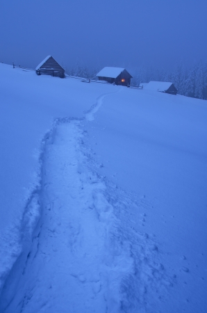 Night landscape with a footpath to a mountain hut in the snow  Ukraine, Carpathian mountains, the valley Kukulの写真素材
