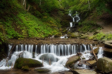 Forest landscape with beautiful waterfall on a mountain river  Cascades cold stream  Beech forest  Carpathians, Ukraine, Europeの写真素材