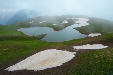 Cloudy day in the mountains with a lake  Caucasus, Georgia, Svaneti, lake Koruldiの写真素材
