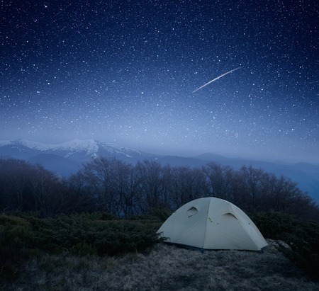 Tourist tent under the stars  Camping at night in the mountainsの写真素材