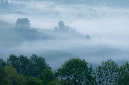 Morning landscape with fog in the mountain village