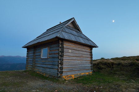 Night landscape with a lonely house in the mountainsの写真素材