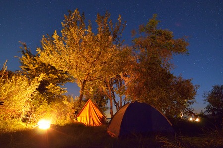 Night landscape with a tent in the mountains  The light from the lantern in a tent  Camping in the countryside  Crimea, Ukraine, Europeの写真素材